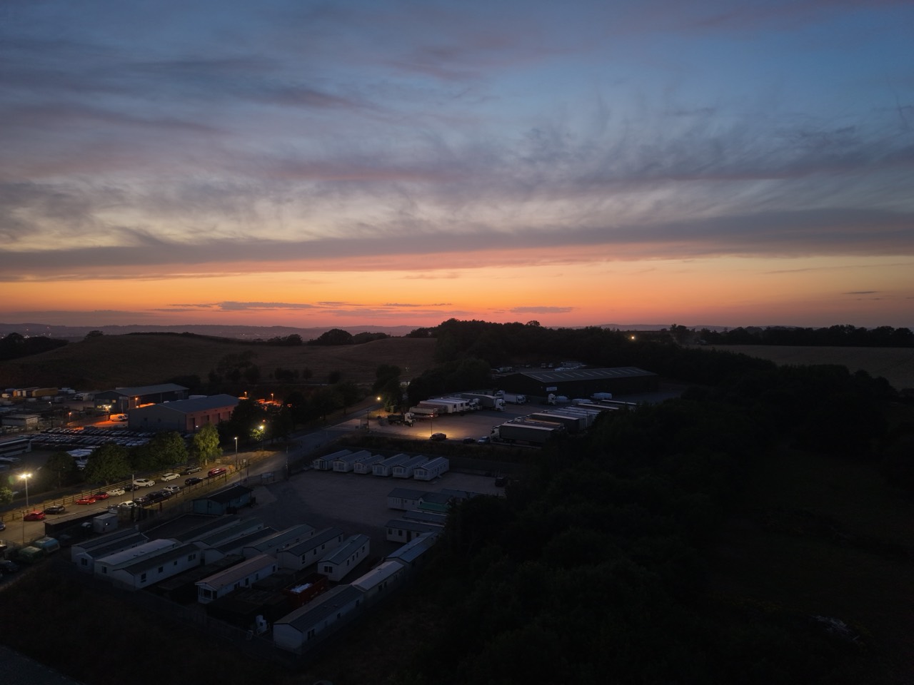 Aerial photograph of a sunset above buildings and countryside
